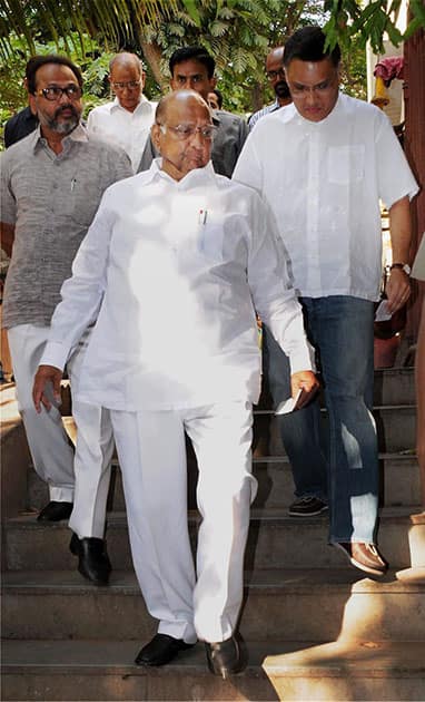 NCP, Chief Sharad Pawar along with his son-in-law Sadanand Sule (R) arrives to cast his vote for the Lok Sabha elections 2014 in Mumbai.