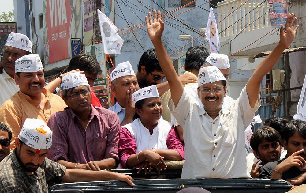 AAP convener Arvind Kejriwal with party leaders during a road show on the way to file his nomination papers in Varanasi.