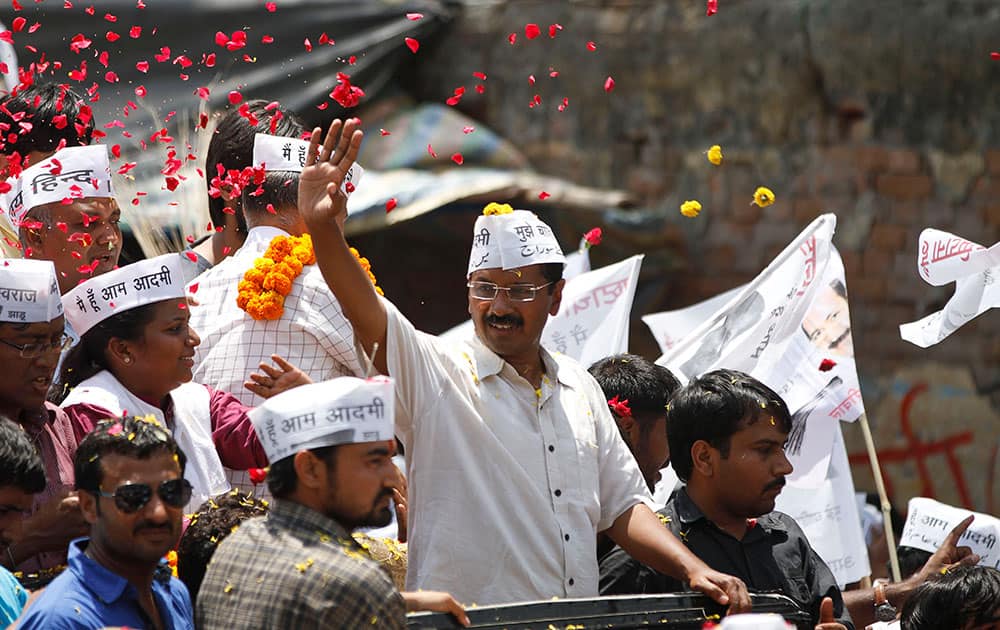 Leader of the Aam Aadmi Party (AAP), or Common Man’s Party, Arvind Kejriwal waves to supporters as he arrives to file his nomination in Varanasi, in the northern Indian state of Uttar Pradesh.