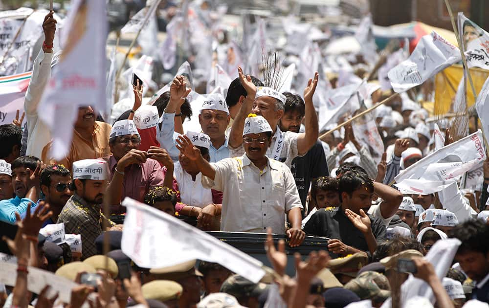 Leader of the Aam Aadmi Party (AAP), or Common Manâ??s Party, Arvind Kejriwal waves to supporters as he arrives to file his nomination in Varanasi, in the northern Indian state of Uttar Pradesh.