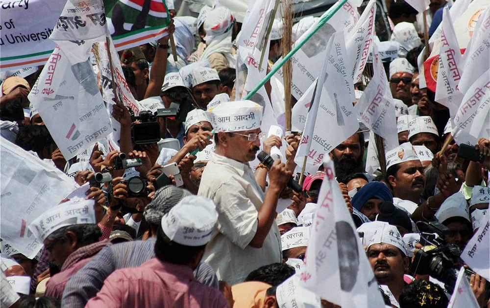 AAP convener Arvind Kejariwal addressing to supporters at a roadshow before filing his nomination papers in Varansi.