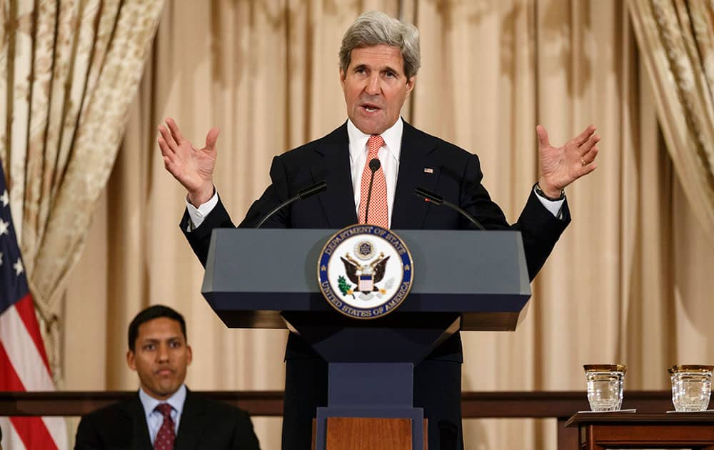 Secretary of State John Kerry, accompanied by Rajiv Shah, administrator of the U.S. Agency for International Development, announces the launch of second Quadrennial Diplomacy and Development Review during a speech at the State Department in Washington.