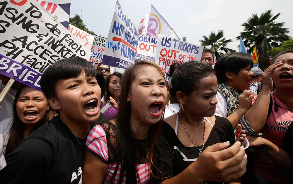 Protesters shout slogans during a rally at US Embassy against next week`s visit of US President Barack Obama, in Manila, Philippines. 