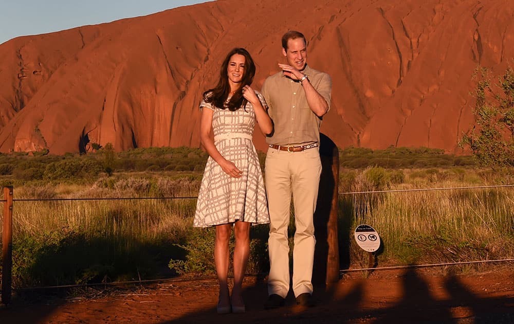 Britain`s Prince William and his wife, Kate, Duchess of Cambridge, pose for a photo at sunset in Uluru, Australia.