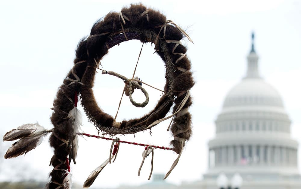 The tip of a Native American prayer stick, is seen near the Capitol dome during a `Reject and Protect` rally by farmers, ranchers and cowboys, and Native Americans to protest against the Keystone XL tar sands pipeline, in Washington.