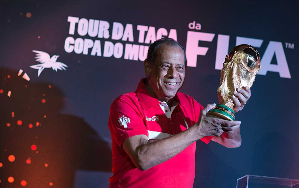 Former Brazilian soccer captain Carlos Alberto Torres holds up the World Cup trophy which is on tour at Maracana stadium as part of the FIFA World Cup Trophy Tour in Rio de Janeiro, Brazil.