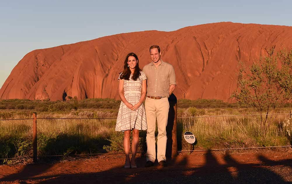 Britain`s Prince William and his wife, Kate, Duchess of Cambridge, pose for a photo at sunset in Uluru, Australia.