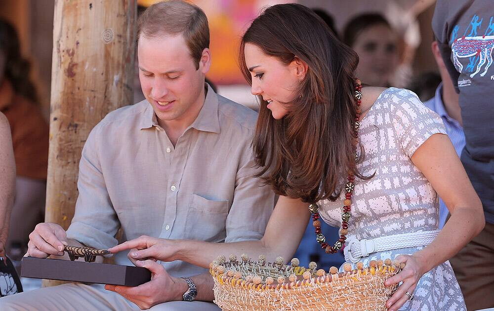 Britain`s Prince William and Kate, the Duchess of Cambridge, look at gifts they received from the local aboriginal community at the Uluru Cultural Center at Uluru, Australia.