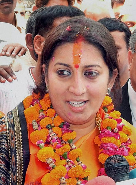 BJP candidate Smriti Irani talks to media at a roadshow before filing her nomination papers for Lok Sabha polls in Amethi.