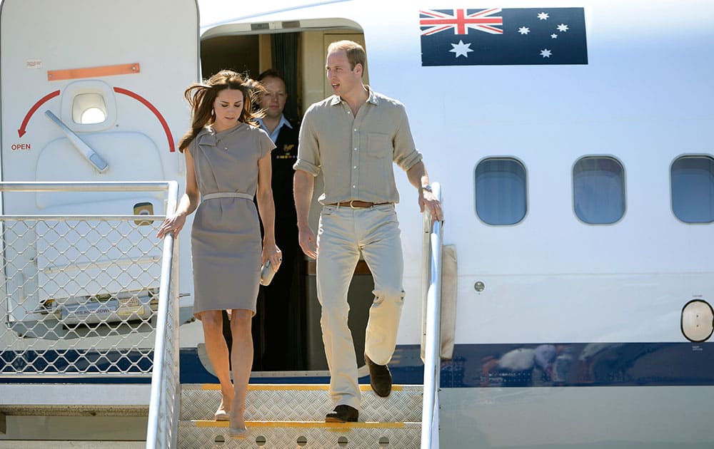 Britain`s Prince William, right, and his wife Kate, the Duchess of Cambridge, arrive at Ayers Rock Airport, in Yulara, Australia.