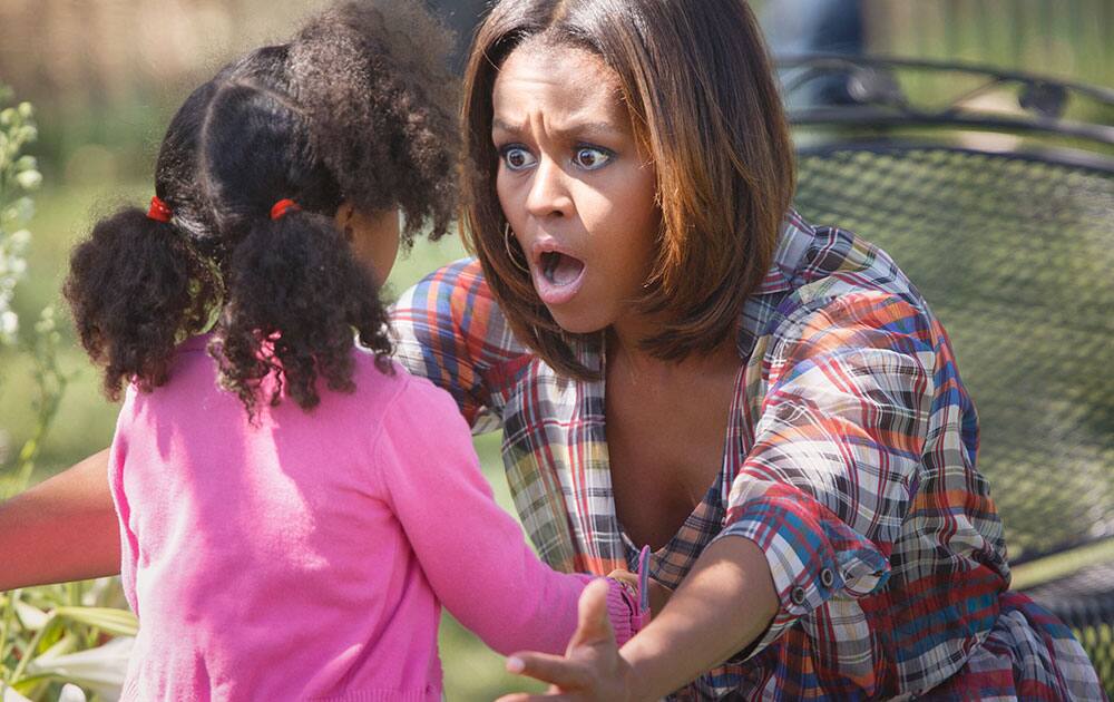 A youngster gets an enthusiastic hug from first lady Michelle Obama after she read to a group of children during the annual White House Easter Egg Roll, on the South Lawn of the White House in Washington.