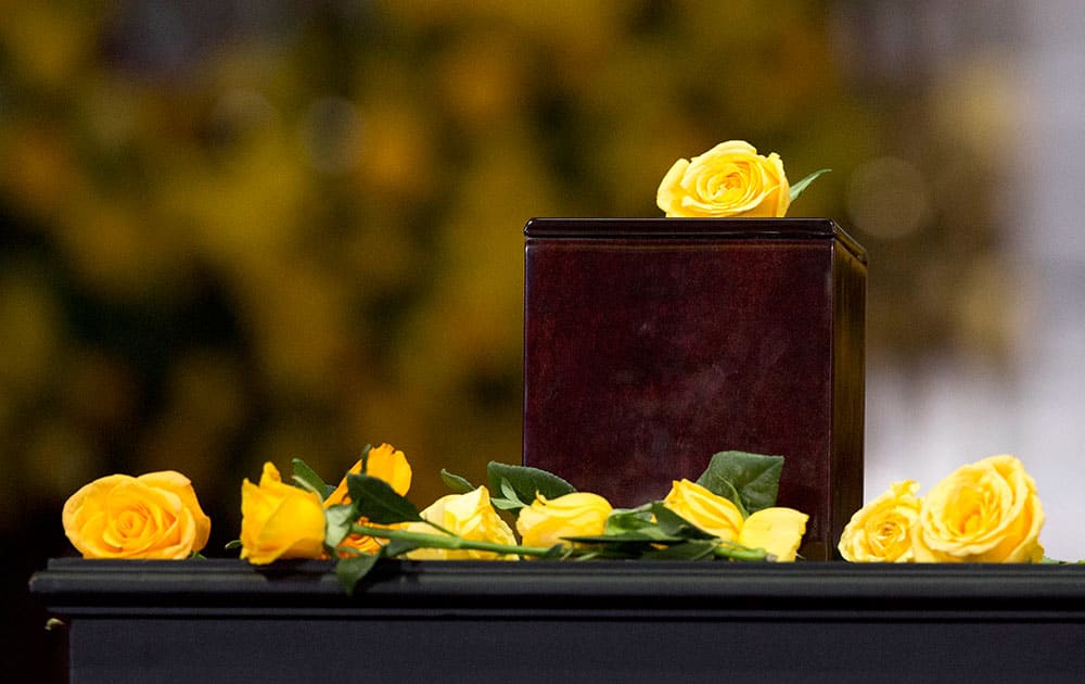 Yellow roses brought by guests surround the urn containing Colombian Nobel Literature laureate Gabriel Garcia Marquez`s ashes during an homage to the beloved author at the Palace of Fine Arts in Mexico City.