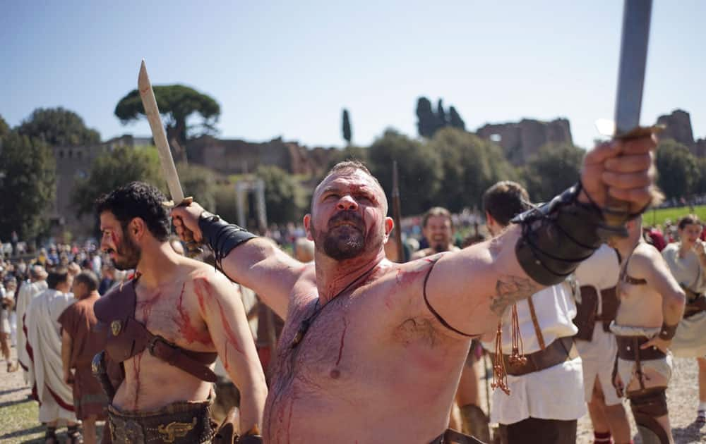 A performer dressed in traditional ancient Roman costume prepares to parade along the ancient Roman ruins of the Colosseum, Circus Maximus and the Roman Forum to celebrate the festivities of the Christmas of Rome, at Circus Maximus