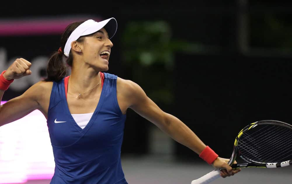 France`s Caroline Garcia reacts after defeating United States` Madison Keys during a Fed Cup world group playoff tennis match between the United States and France at Chaifetz Arena in St. Louis. Garcia won 6-4, 6-3.