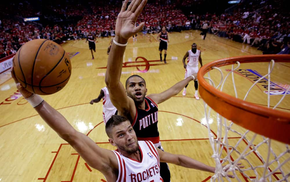 Houston Rockets` Chandler Parsons (25) goes up for a shot as Portland Trail Blazers` Nicolas Batum defends during the first half in Game 1 of an opening-round NBA basketball playoff series,in Houston.