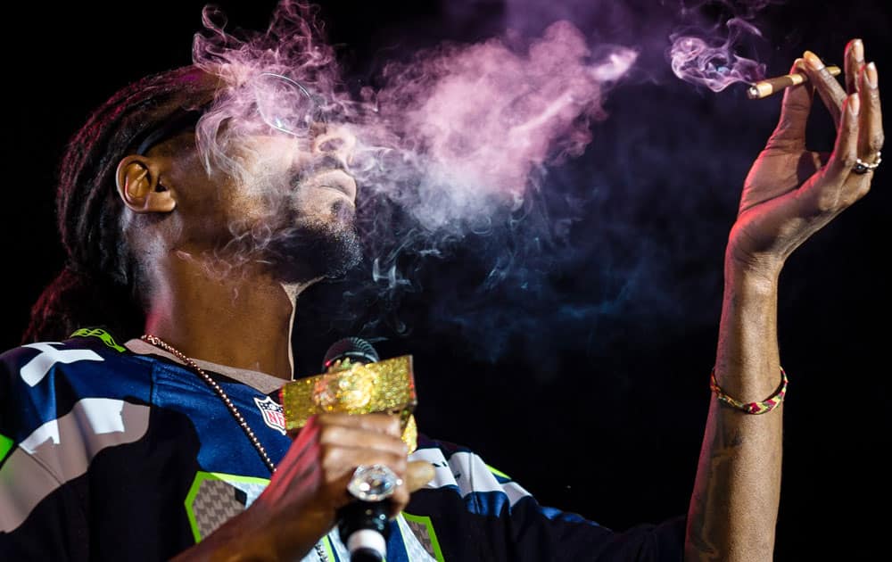 Snoop Dogg exhales lungfuls of blunt smoke on stage during “Snoop`s Wellness Retreat” tour Saturday. at WaMu Theater in Seattle, Wash.