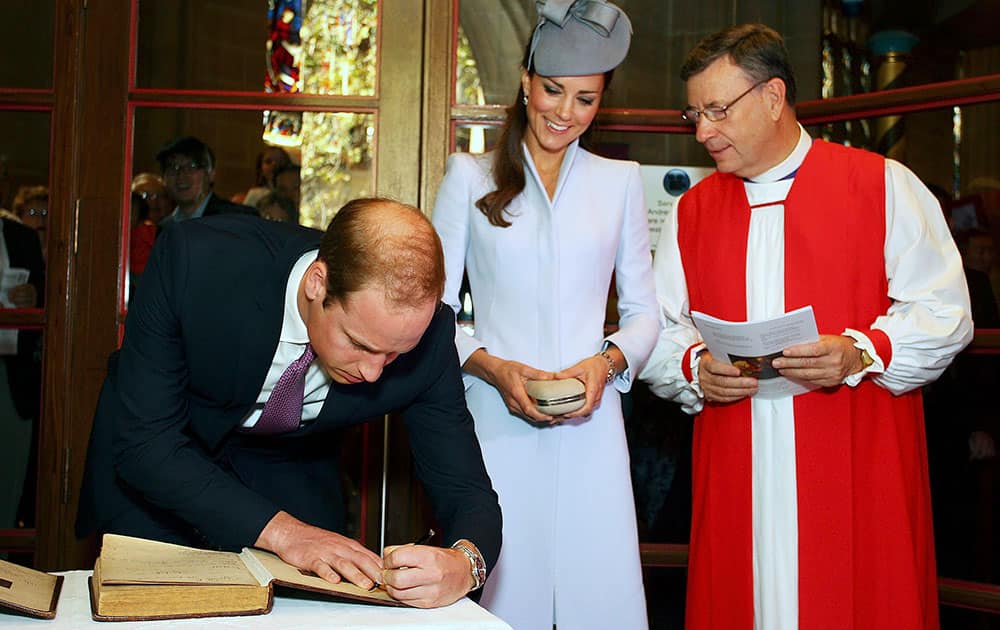 Britain`s Prince William, left, signs the First Fleet Bible and Prayer Book as his wife, Kate, the Duchess of Cambridge, center, and The Most Reverend Glenn Davies, Archbishop of Sydney watch following an Easter Sunday service at St. Andrews Cathedral in Sydney.