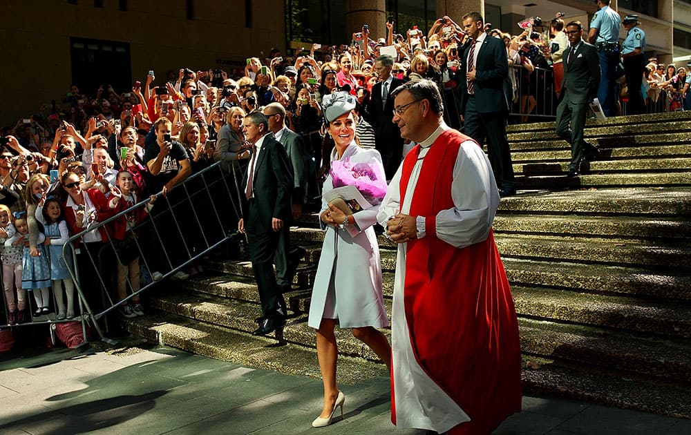 Britain`s Kate, the Duchess of Cambridge, center, walks with The Most Reverend Glenn Davies, Archbishop of Sydney, right, following an Easter Sunday service at St. Andrews Cathedral in Sydney.