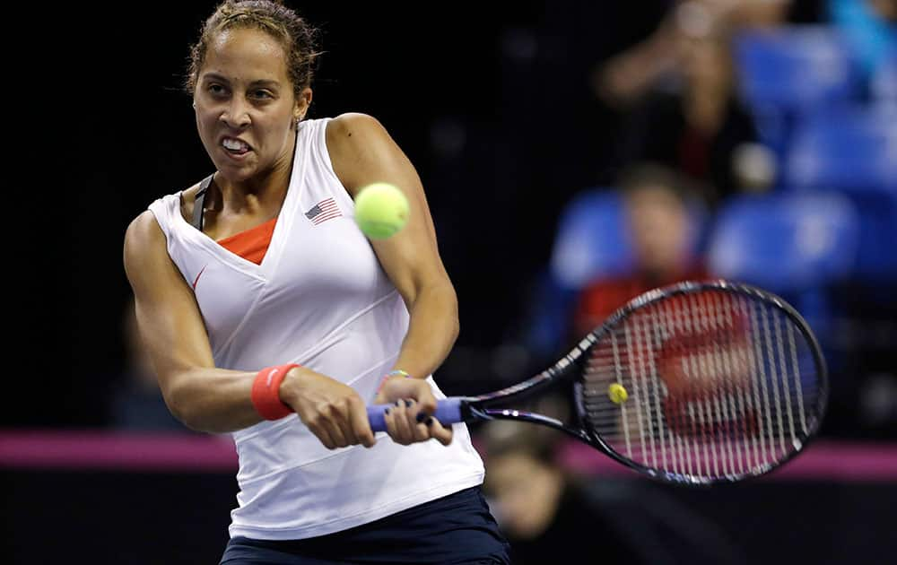 United States` Madison Keys returns the ball to France`s Alize Cornet during a Fed Cup singles world group playoff tennis match in St. Louis. 