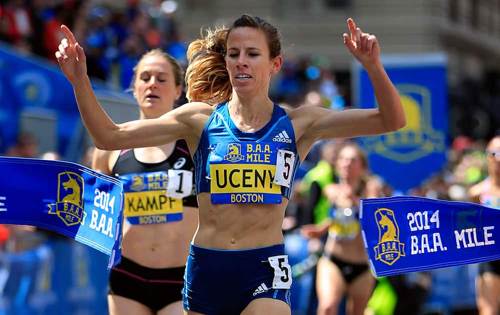 Morgan Uceny breaks the tape to win the women`s division of the B.A.A. Invitational Mile in Boston, in advance of Monday`s 118th Boston Marathon.