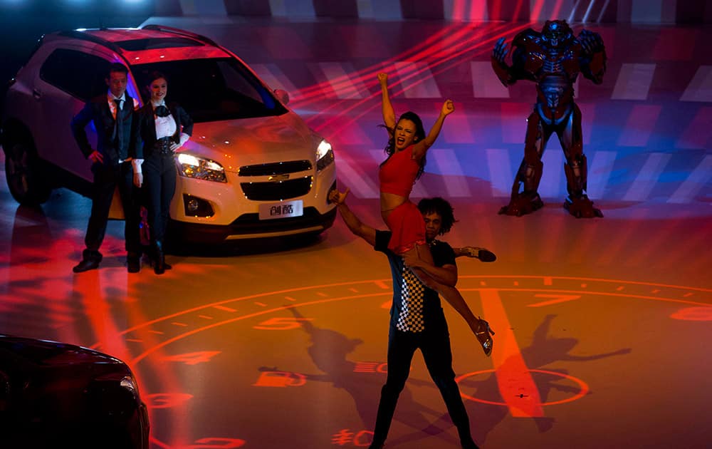 Performers dance near Trax a Chevrolet urban SUV during it`s China launch ahead of Auto China 2014 in Beijing, China.