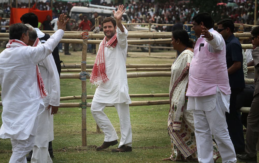 Rahul Gandhi waves to the crowd during an election rally in Nagaon, in the northeastern Indian state of Assam.