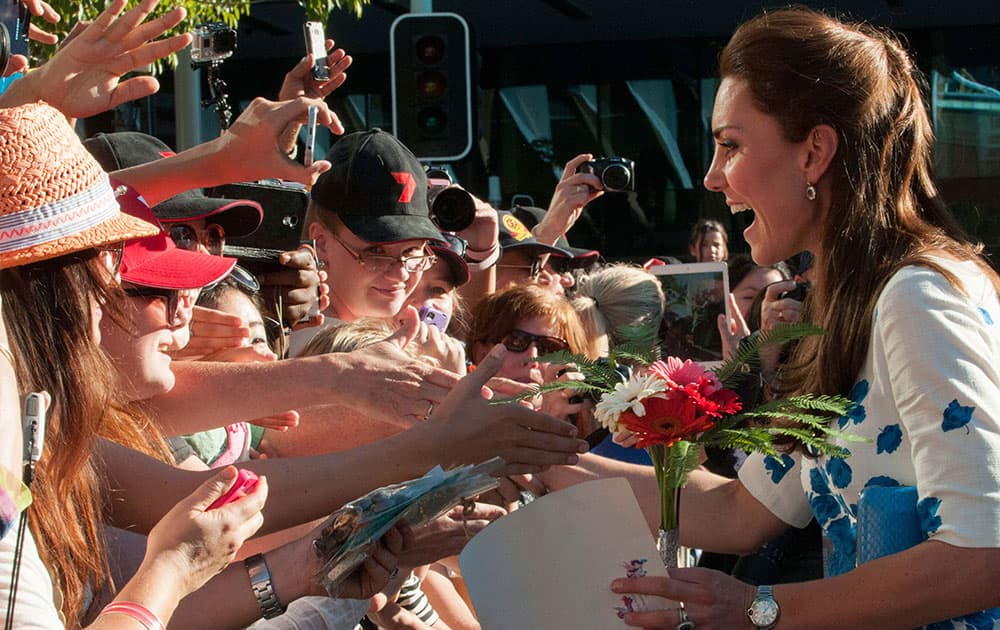 Kate, the Duchess of Cambridge, right, meets members of the public after attending a reception at the Brisbane Convention & Exhibition Centre, in Brisbane.