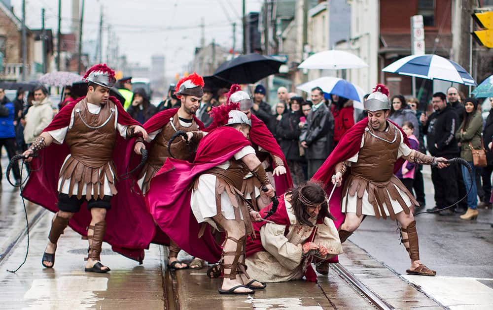 Fabio Gesufatto portrays Jesus as he is set upon by Roman Guards during the Good Friday procession in Toronto`s Little Italy neighbourhood.