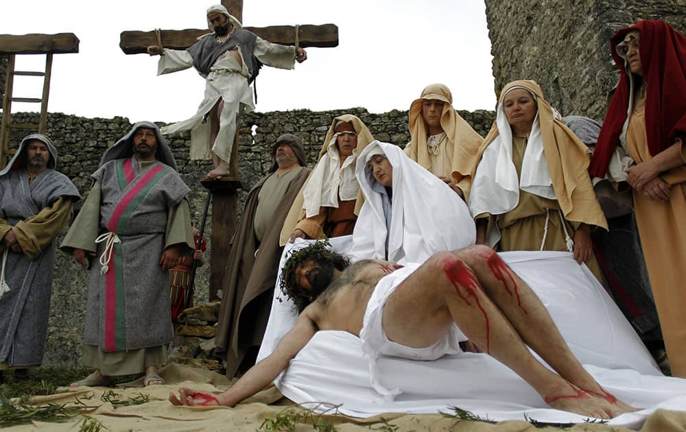 Worshippers perform the Stations of the Cross during the celebrations of the Holy Week in Ourem, Portugal.