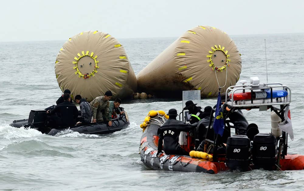 South Korean rescue members search passengers believed to have been trapped in the sunken ferry Sewol near the buoys which were installed to mark the area in the water off the southern coast near Jindo, south of Seoul, South Korea.