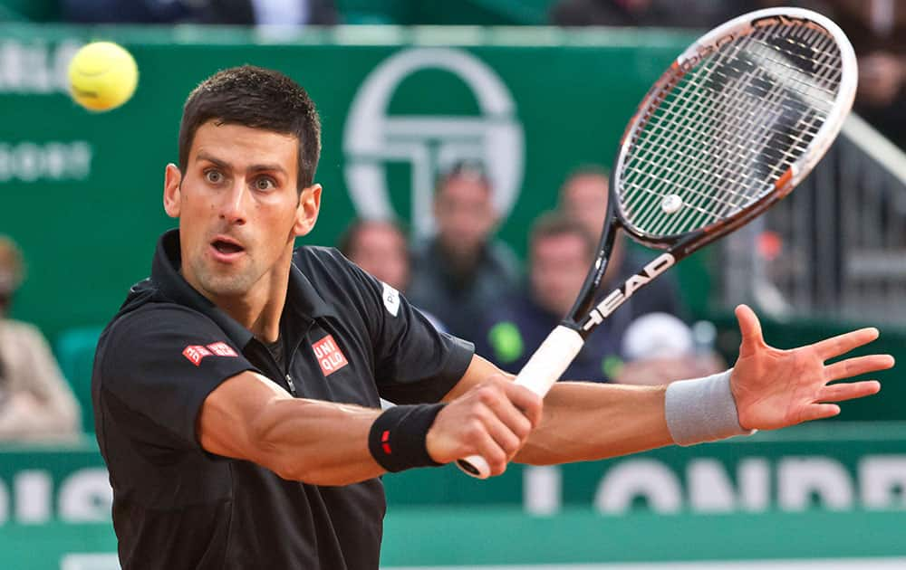 Novak Djokovic of Serbia returns the ball to Guillermo Garcia-Lopez of Spain during their quarterfinals match of the Monte Carlo Tennis Masters tournament in Monaco.