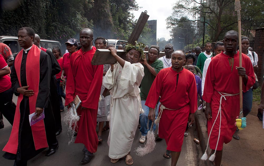 Christians of the Catholic Church in Kenya carry the cross through the streets of Nairobi, Kenya during the Holy Week. Easter marks the end of Lent, a forty-day period of fasting, prayer, and penance.