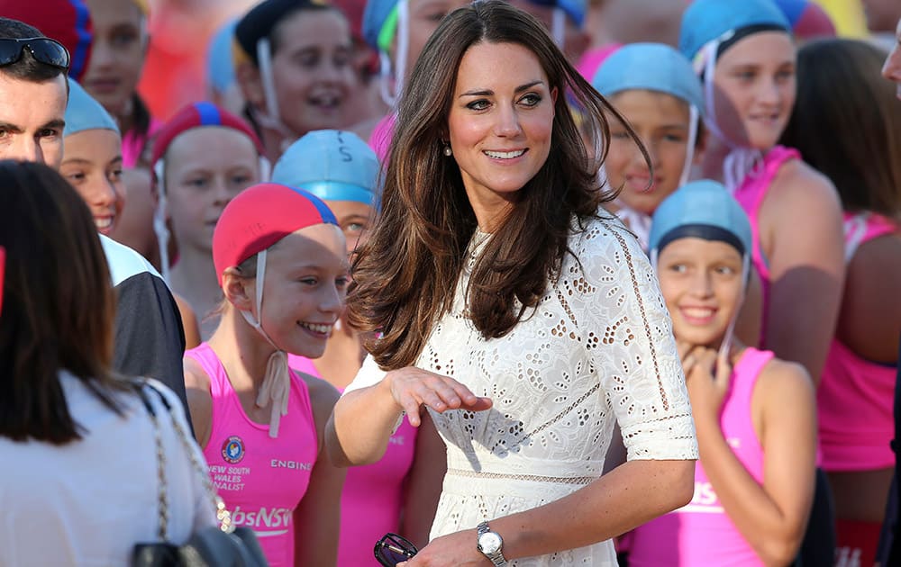 Britain`s Kate, the Duchess of Cambridge waves to fans during a visit to a surf life saving carnival at Manly Beach in Sydney, Australia.