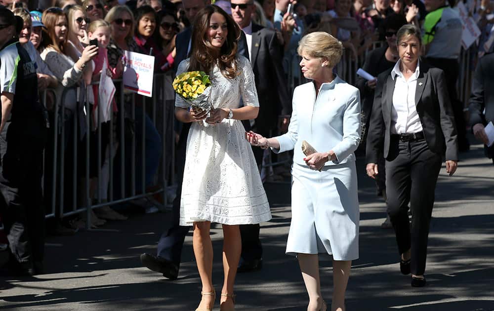 Britain`s Kate, the Duchess of Cambridge smiles while walking with Jennifer Dudley, wife of Glenn Dudley, president of the Royal Agricultural Society, during a tour of the Sydney Easter Show in Sydney.