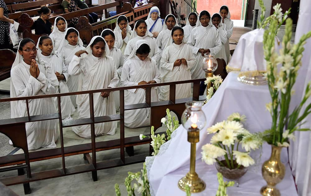 Catholic nuns of Missionaries of Charity, the order founded by Mother Teresa, pray during Good Friday Mass at a church in Kolkata.