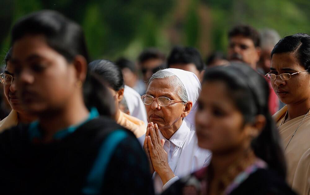 Christian devotees pray outside the St. Joseph Cathedral on Good Friday in Allahabad.