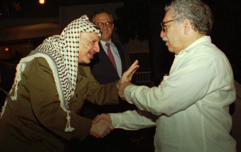 FILE - In this Oct. 20,1995 file photo, PLO Leader Yasser Arafat greets Nobel laureate Colombian Nobel laureate Gabriel Garcia Marquez during the closing ceremonies of the Non-Aligned Summit in Cartagena, Colombia.