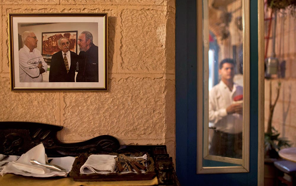 A framed picture of Fidel Castro with Gabriel Garcia Marquez and Tomas Erasmo Hernandez, signed by Castro, hangs inside the private restaurant Mama Ines in Old Havana, Cuba.