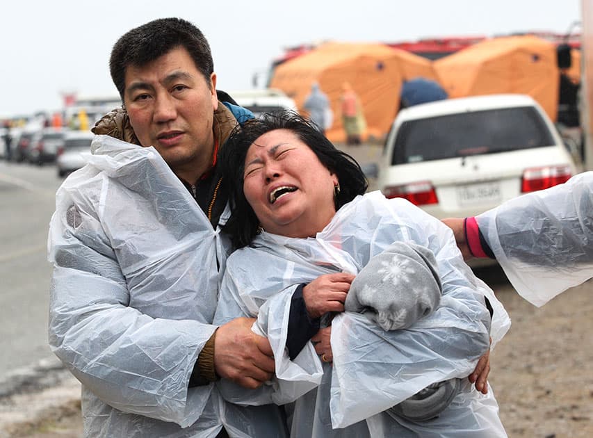 A relative of a passenger aboard a sunken ferry weeps at a port in Jindo, South Korea.