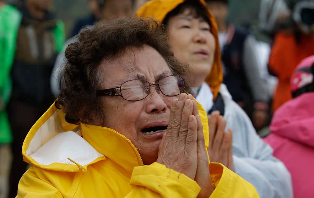 One of relatives of passengers aboard a sunken ferry cries during a Buddhist ceremony to pray for speedy rescue and their safety at a port in Jindo, south of Seoul, South Korea.