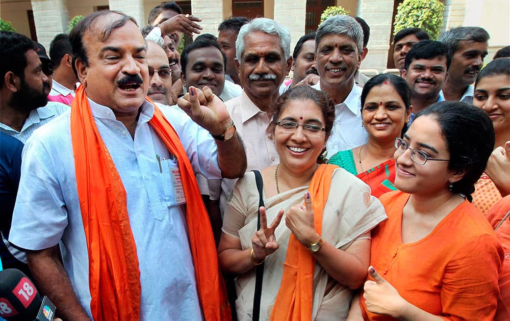 BJP candidate from Bangalore South Ananth Kumar showing his inked finger along with his family after casting votes at a polling station in Bengaluru.
