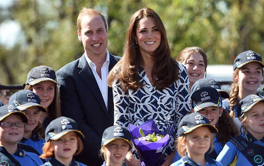 Britain`s Prince William and his wife Kate, the Duchess of Cambridge, pose for a photo near where a tree is planted at a Girl Guide hall at Winmalee, Australia.