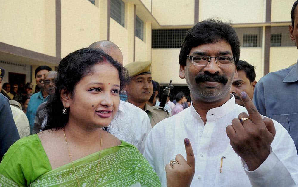 Jharkhand CM Hemant Soren and his wife show ink marked finger after casting their vote for Lok Sabha election in Ranchi.