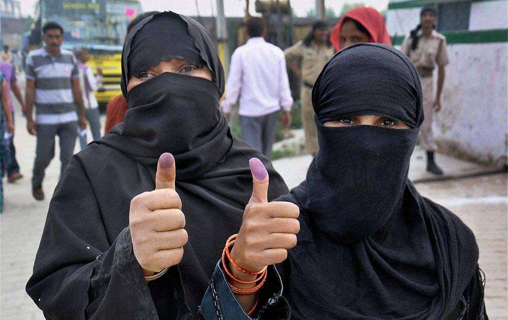 Muslim women show ink marked finger after casting their vote for Lok Sabha election in Moradabad, UP.