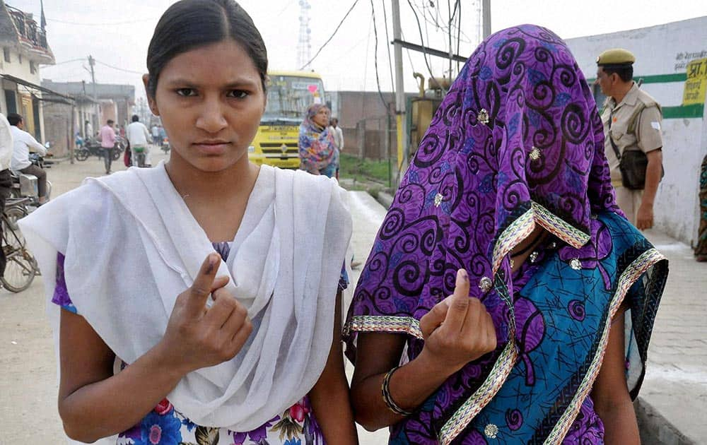 Women voters flaunt their inked fingers after casting their vote in Moradabad, UP.