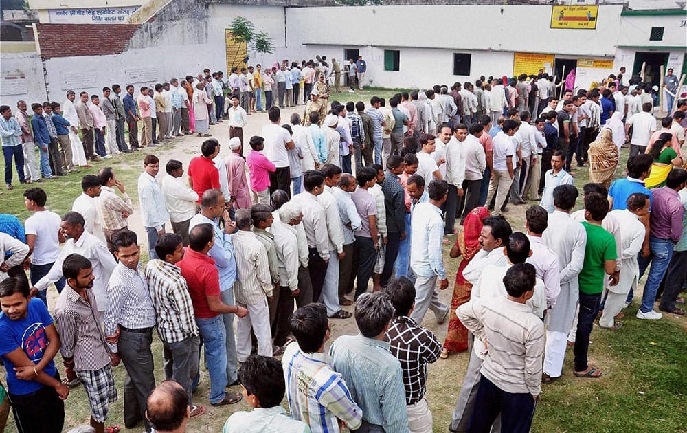 Voters stand in queue to cast their vote for Lok Sabha elections in Moradabad, Uttar Pradesh.