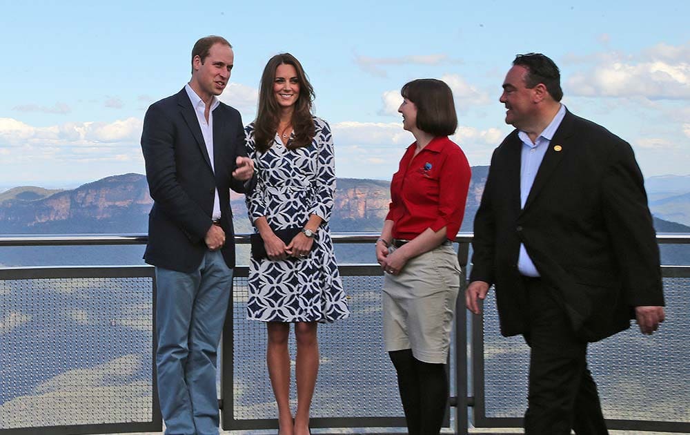 Britain`s Prince William, left, and his wife Kate, the Duchess of Cambridge, second left, stand with Randall Walker, right, chief executive officer of Blue Mountains Lithgow and Oberon Tourism and Anthea Hammon, joint managing director of Scenic World at Echo Point Lookout in Katoomba, Australia.
