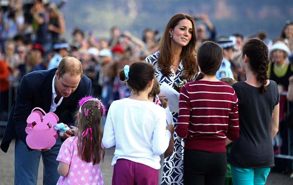 Britain`s Prince William, left, and his wife, Kate, the Duchess of Cambridge, third left, speak with a group of young children during a tour of Echo Point in Katoomba, Australia.