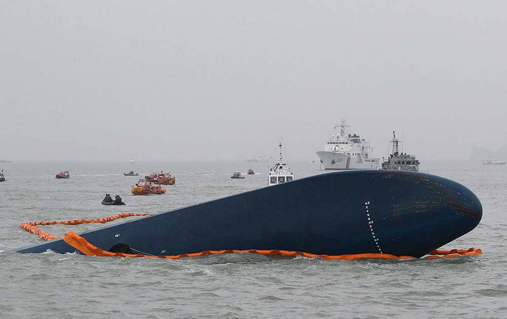 South Korean Coast Guard officers search for missing passengers aboard a sunken ferry in the water off the southern coast near Jindo, South Kore.