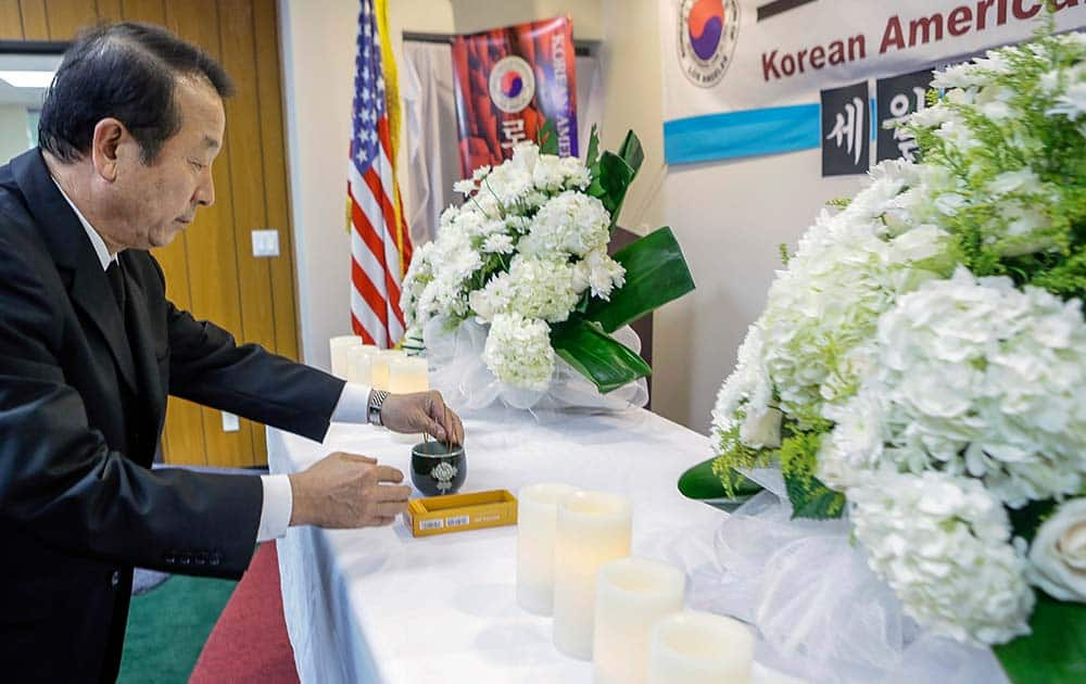 Mon Han Bae, president of the Korean American Federation of Los Angeles, lights incense, during a vigil for victims aboard the sunken South Korean ferry boat, at the Korean Federation of Los Angeles.